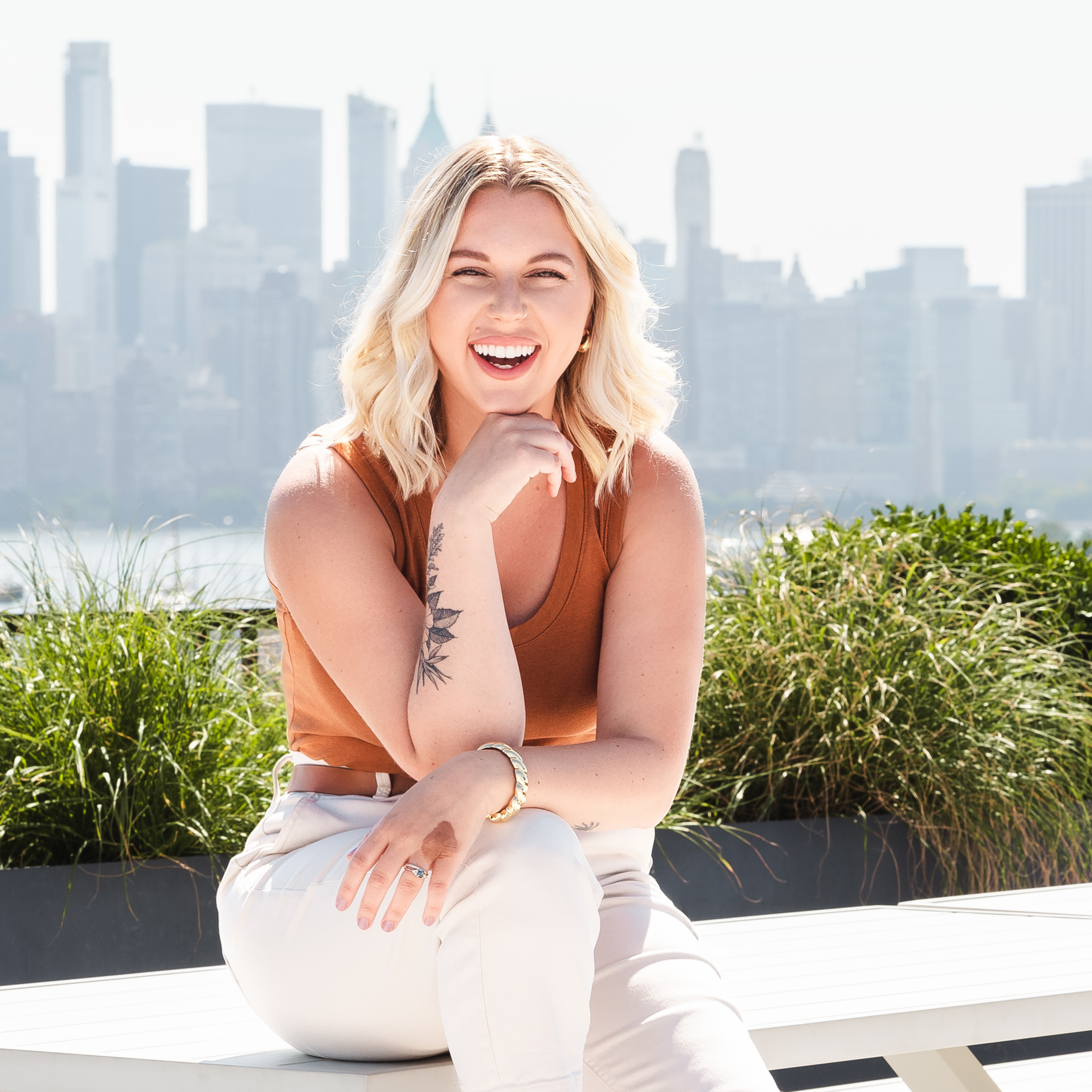 Bri sitting infront of a NYC back drop.